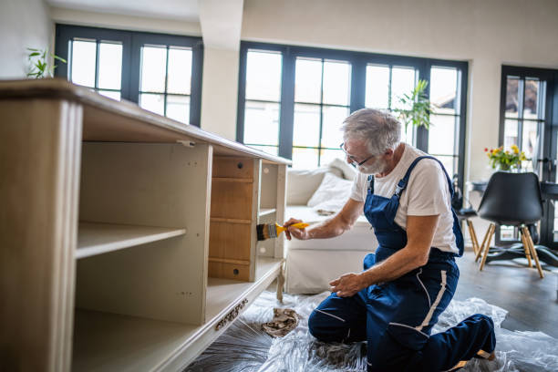 istock Senior man restoring a showcase at home 1279269789