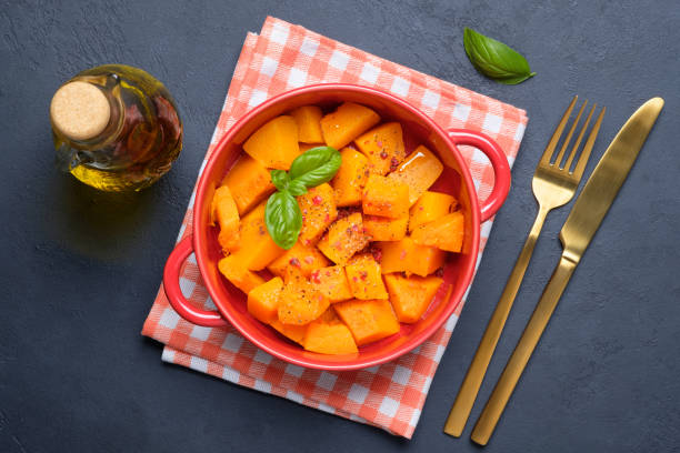 baked pumpkin on black concrete background. - portion pumpkin vegetable black imagens e fotografias de stock