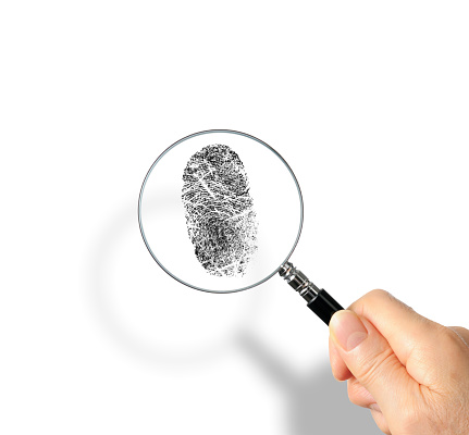 Holding a magnifying glass to see fingerprints, isolated on white with shadow.