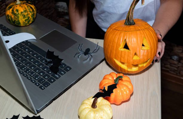 istock Working hours of a freelancer during the Halloween celebration. Pumpkins and decorations next to your laptop. 1279274949