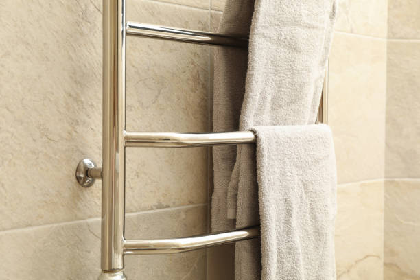 istock Modern heated towel rail on tiled bathroom wall 1279275007