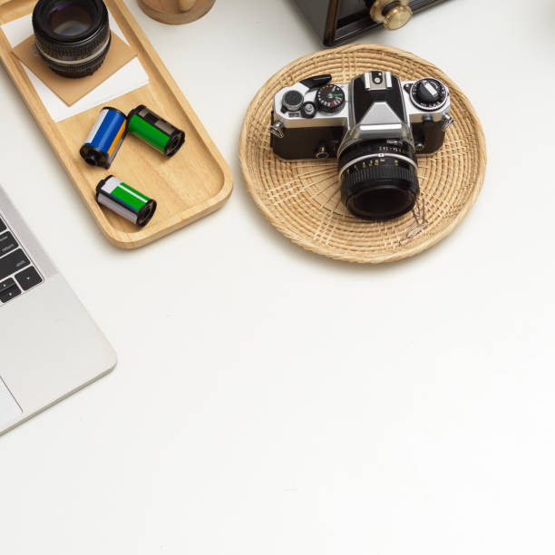 istock Worktable with camera, laptop, supplies and copy space in studio 1279275104