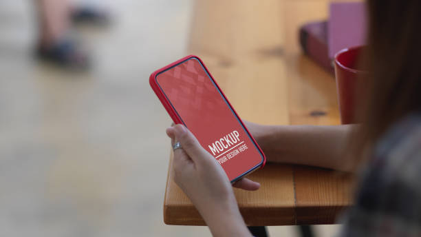 istock Female hand using clipping path smartphone on wooden table in cafe 1279275733