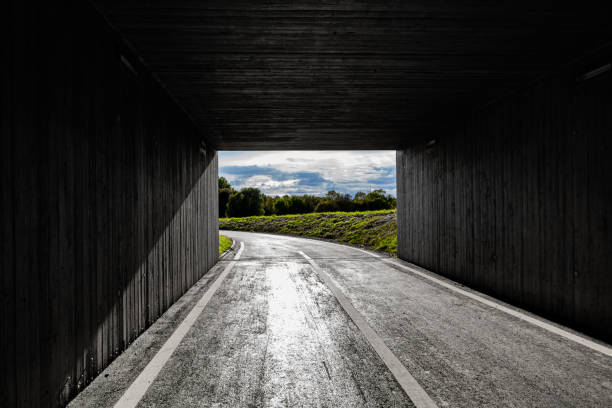 Light and landscape at the end of a dark square tunnel