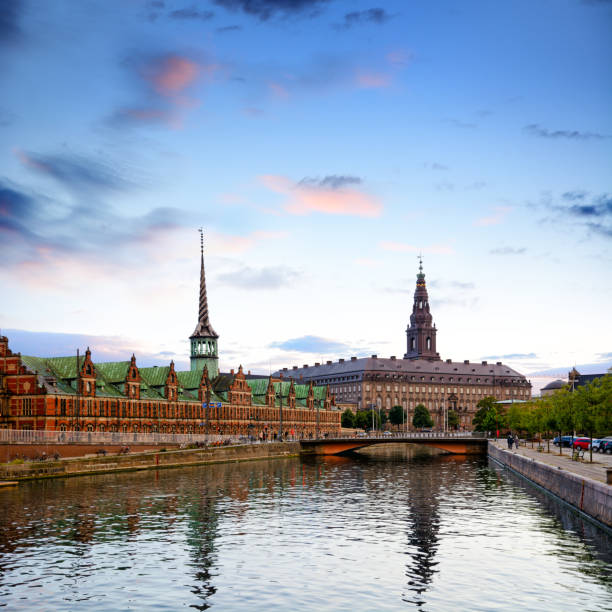 Borsen Building (The Old Stock Exchange) & Christiansborg Palace at sunset, Copenhagen, Denmark. Composite photo