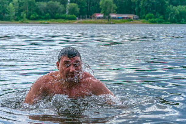 istock A swimmer emerges from under the water, swimming in a refreshing clear river 1279278227