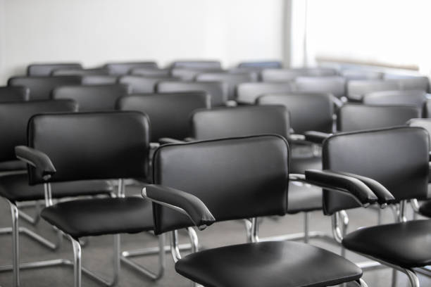 istock Empty black chairs stand in conference hall 1279278591