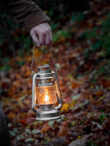 istock Yellow hanging lantern in hand at night. 1279279500