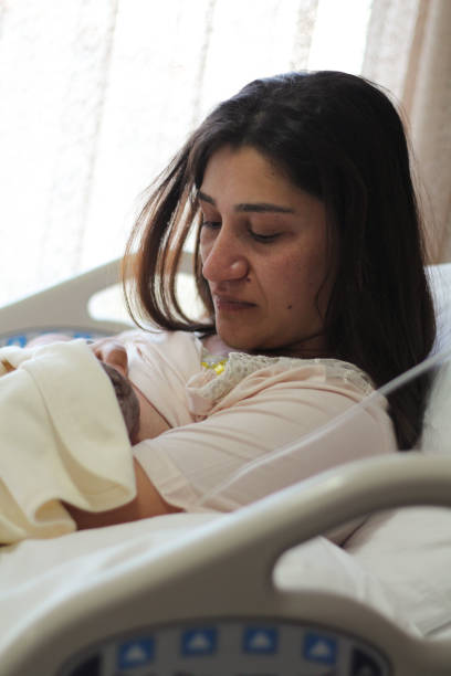 istock Newborn baby with mother, breastfeeding 1279289059