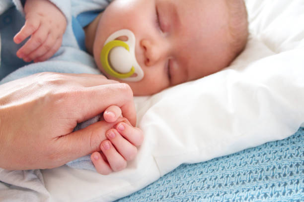 istock Four month old baby sleeping on blue blanket 1279289276