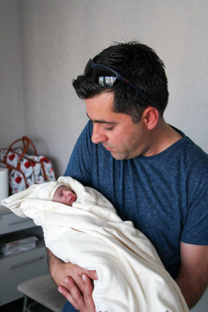 istock Newborn baby with parents 1279289294