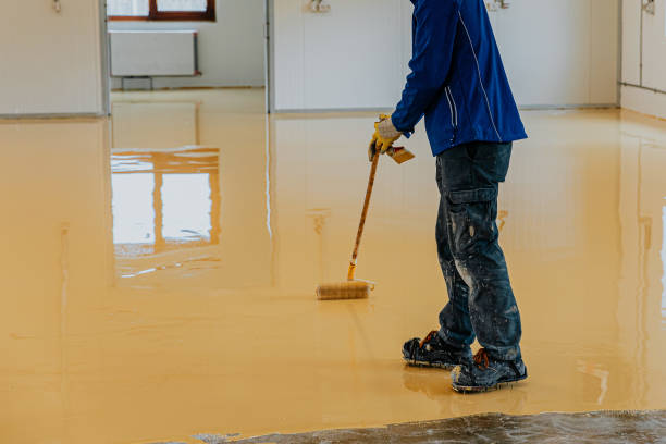 construction workers apply epoxy resin in an industrial hall - levelling instrument imagens e fotografias de stock