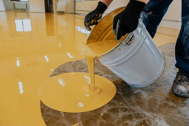 istock A construction worker apply epoxy resin in an industrial hall 1279290260