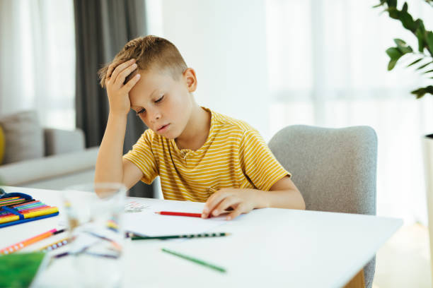 istock Young boy doing his homework. Back to school. Online class from home. 1279290797