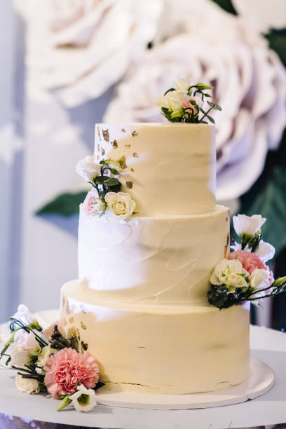 istock Delicious wedding reception. Cake with flowers decoration on a background party decor. Copy space. Celebration concept. Trendy Cake. Close up. 1279295149