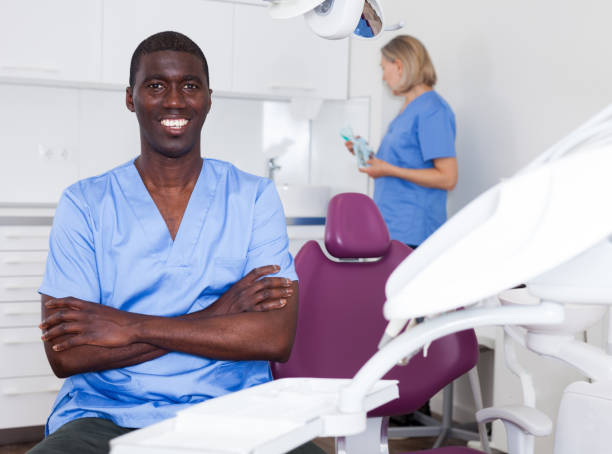 istock Assistant and doctor are meeting next client in clinic 1279295279