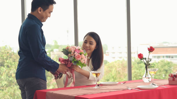 istock Romantic couple giving gift to lover at restaurant 1279295586