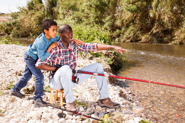 istock Man and boy fishing with rods 1279296062