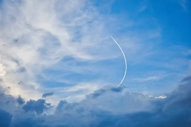 An airplane flies a curve and traces a contrail