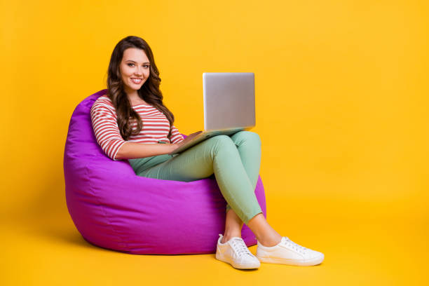 istock Full length body size side profile photo female freelancer sitting working computer isolated on bright yellow color background copyspace 1279296630
