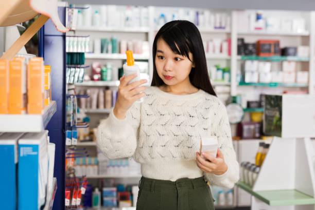 istock Young chinese woman chooses antibacterial at the pharmacy 1279299516