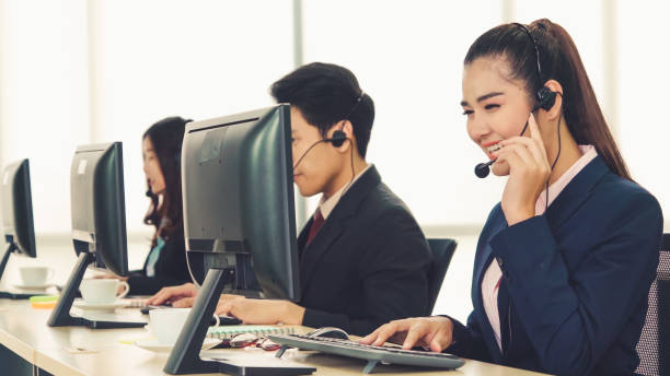 istock Business people wearing headset working in office 1279299619