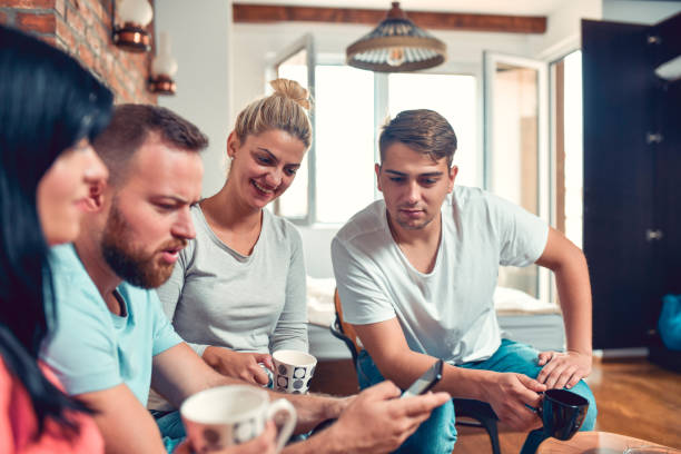 istock Friendly Couples Browsing Social Media While Enjoying Coffee Gathering 1279299674
