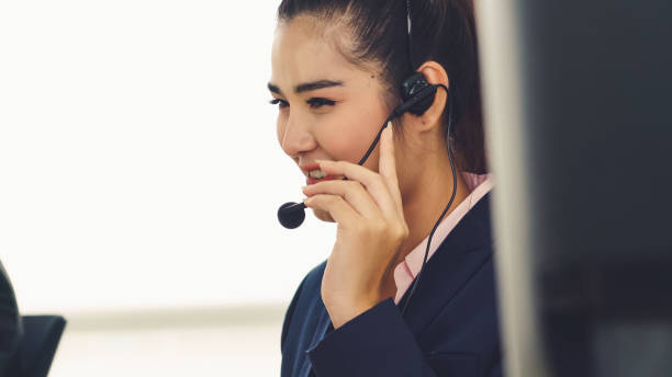 istock Business people wearing headset working in office 1279299762