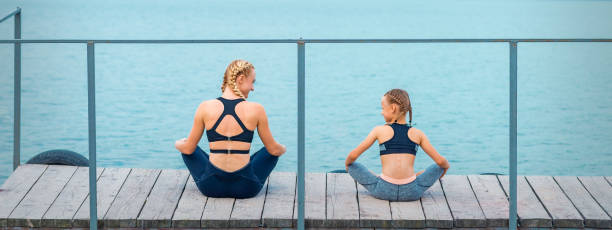 istock Mother and daughter doing gym exercises 1279300780