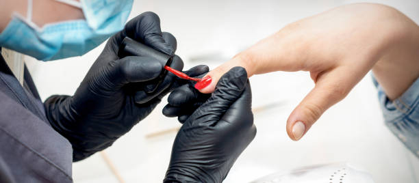 istock Manicure master painting female nails 1279300849