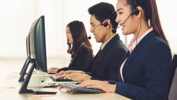 istock Business people wearing headset working in office 1279301048