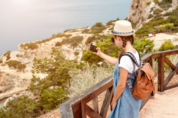 istock Young girl in a hat and dress with a backpack. 1279301124