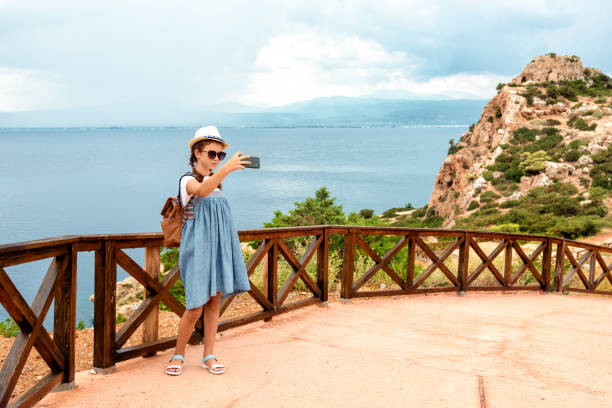 istock Young girl in a hat and dress with a backpack. 1279301130