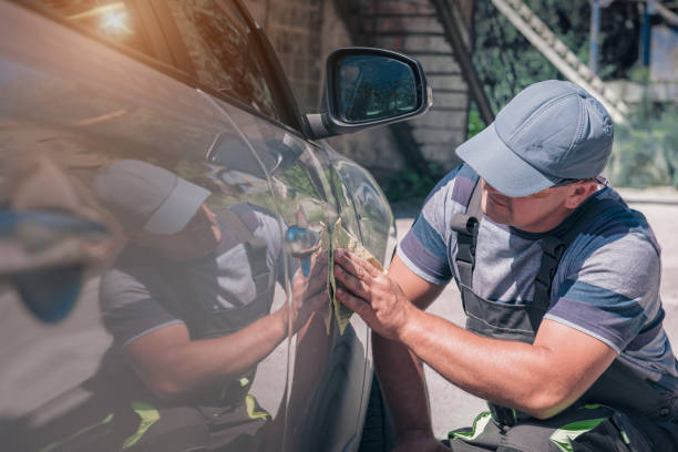 istock An employee of a car service examines a car paintwork. 1279301342