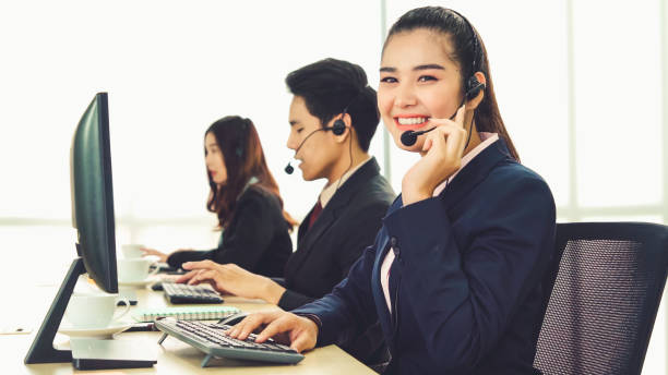 istock Business people wearing headset working in office 1279302994