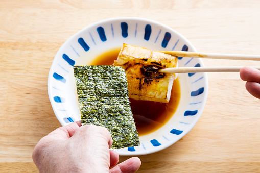 In Japan, soy sauce is added to roasted rice cakes (Moti) and seaweed is wrapped around them.