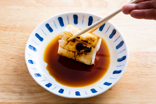 In Japan, soy sauce is added to roasted rice cakes (Moti) and seaweed is wrapped around them.