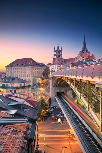 Cityscape image of downtown Lausanne, Switzerland during beautiful autumn sunset.
