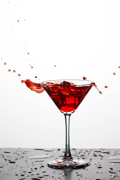 istock Action Splash Photography. Red Wine Glass With Splashes Against White Background. Vertical Image 1279305293