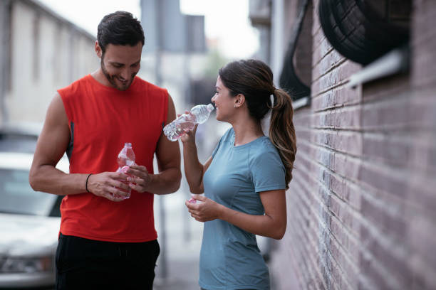 istock Athletic couple is having a rest after jogging in the city. 1279305410