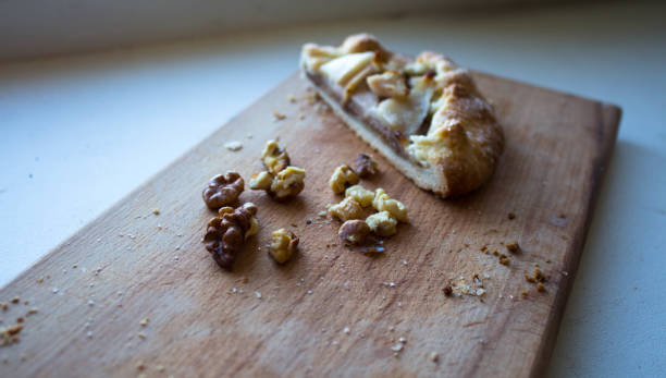 istock a piece of pie with pear and nuts on a wooden plank 1279305555