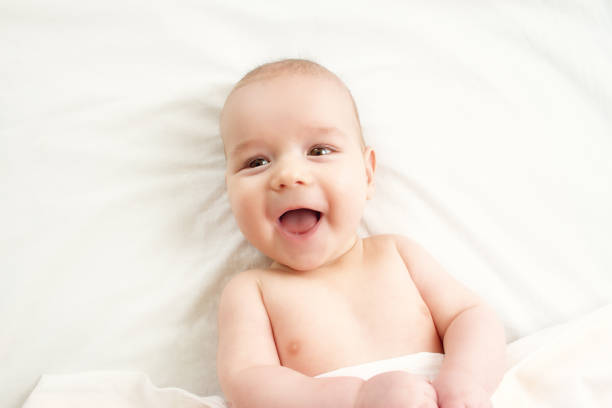 istock Happy baby is lying on a white blanket 1279306508