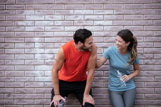 istock Athletic couple is having a rest after jogging in the city. 1279306677
