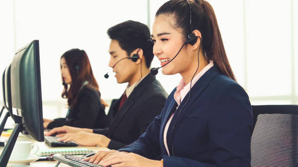 istock Business people wearing headset working in office 1279307397