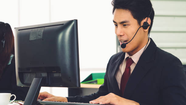 istock Business people wearing headset working in office 1279309103