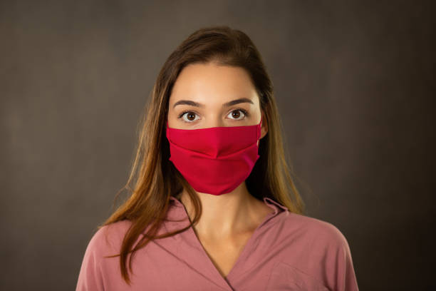 istock Alert girl with protective face mask on looking into camera from front view 1279309243