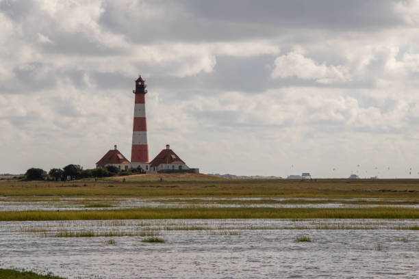 istock Salt marsh at the Westerheversand lighthouse at high tide 1279309877
