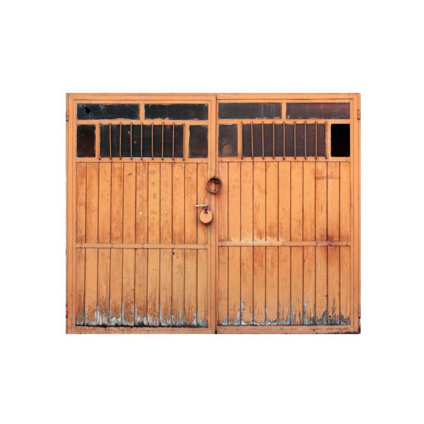 Old yellow wooden garage gate with padlock isolated on white background