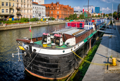 Holidays in Poland - Brda river with old barge and Old Town buildings in Bydgoszcz