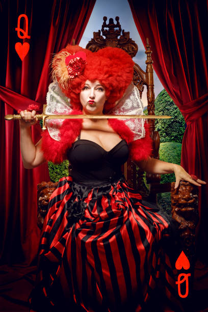Queen of Hearts like female character on a throne in a studio shot